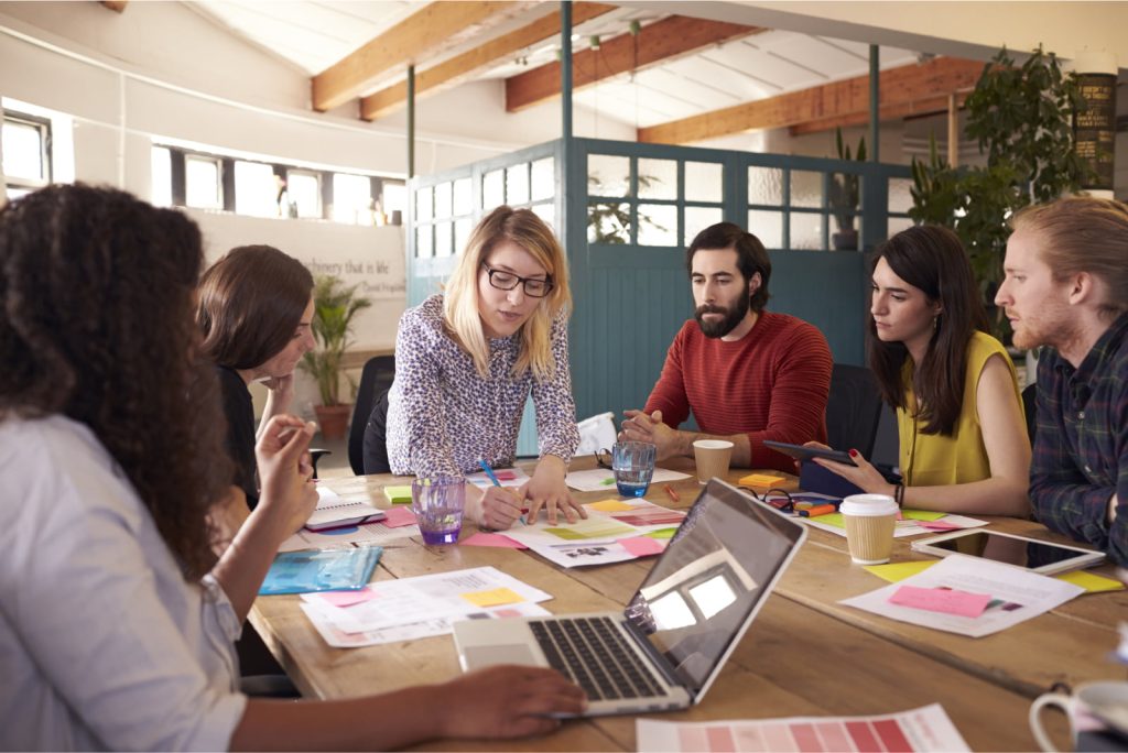 Female manager leading a brainstorming meeting in a design office.