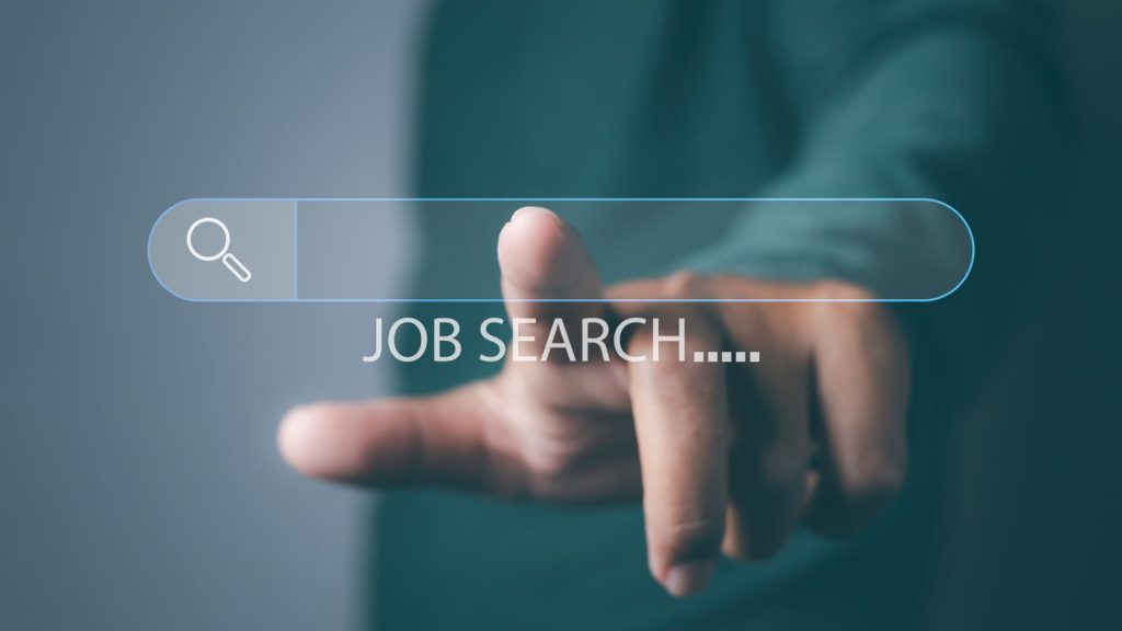 Finger reaching out to touch a search bar with "Job Search..." underneath, symbolizing online job searching.