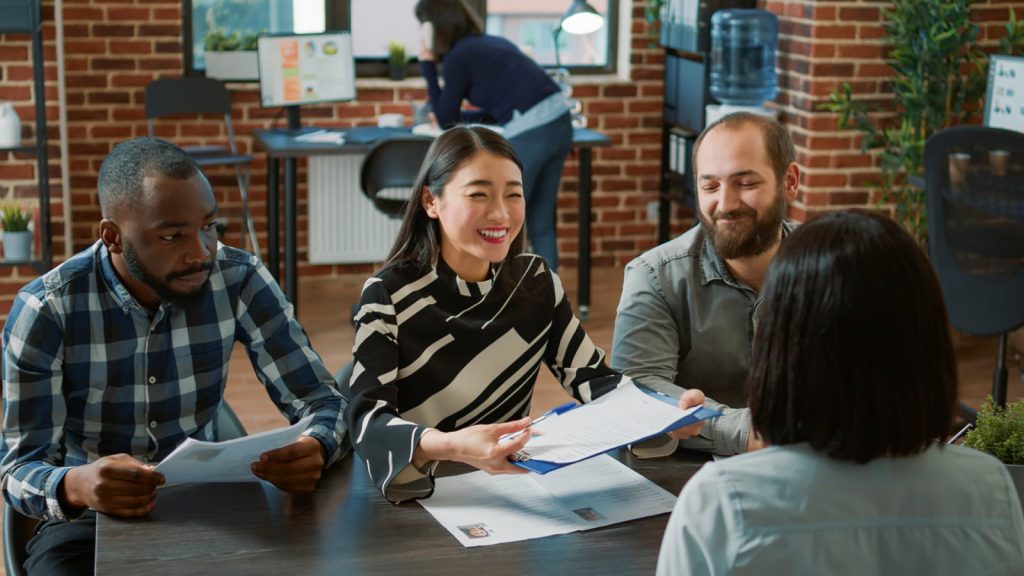 HR workers making an employment deal with a woman after a successful job interview.