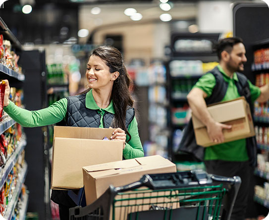 Retail employees stocking shelves in a grocery store, symbolising efficiency in retail operations.