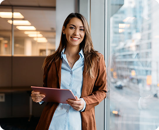 A businesswoman holding a tablet, symbolizing modern leadership in the corporate world.