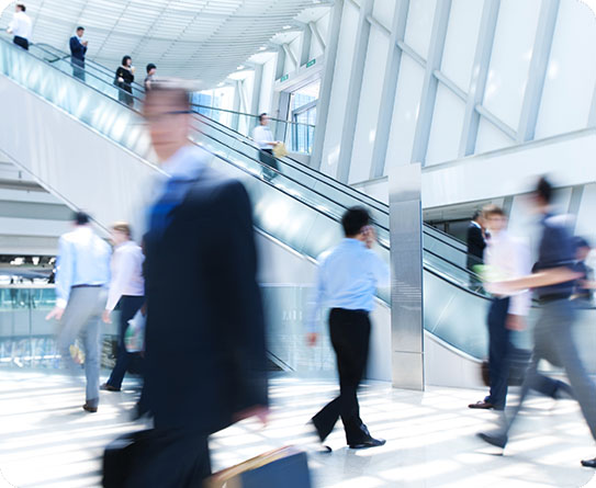 Business professionals walking through a modern office complex, symbolising dynamic property and facilities management.