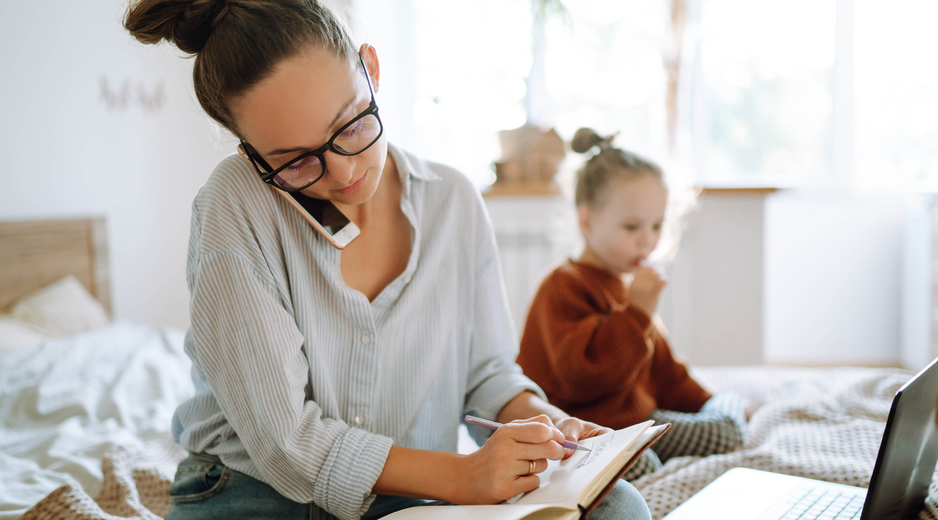 Parent working at home, while looking after child