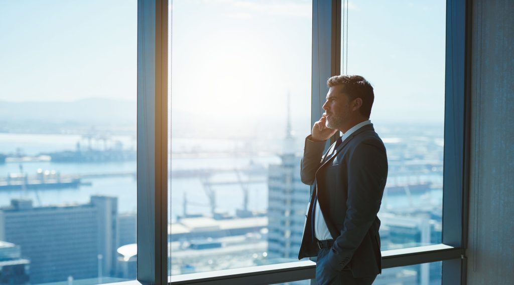 Image of a man in a suit on a phone call