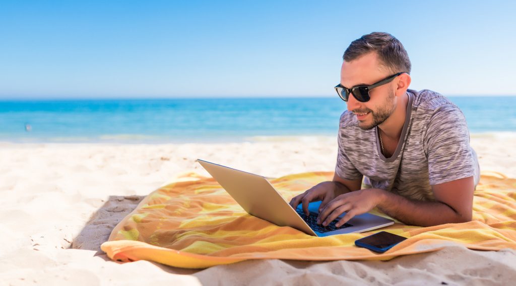 Person on the beach looking for a new job for 2025
