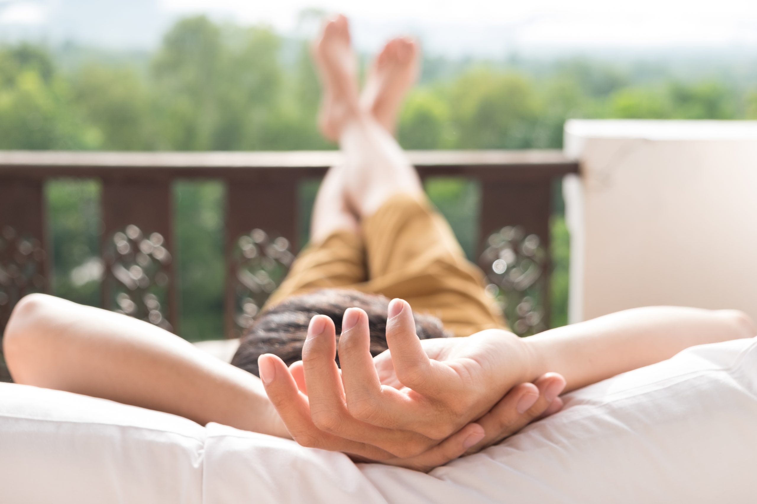 Young man relax on bed and enjoying mountain view.