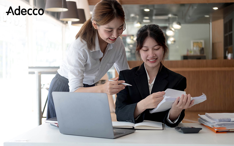 Copy of 01 Two professionals collaborating to streamline HR processes