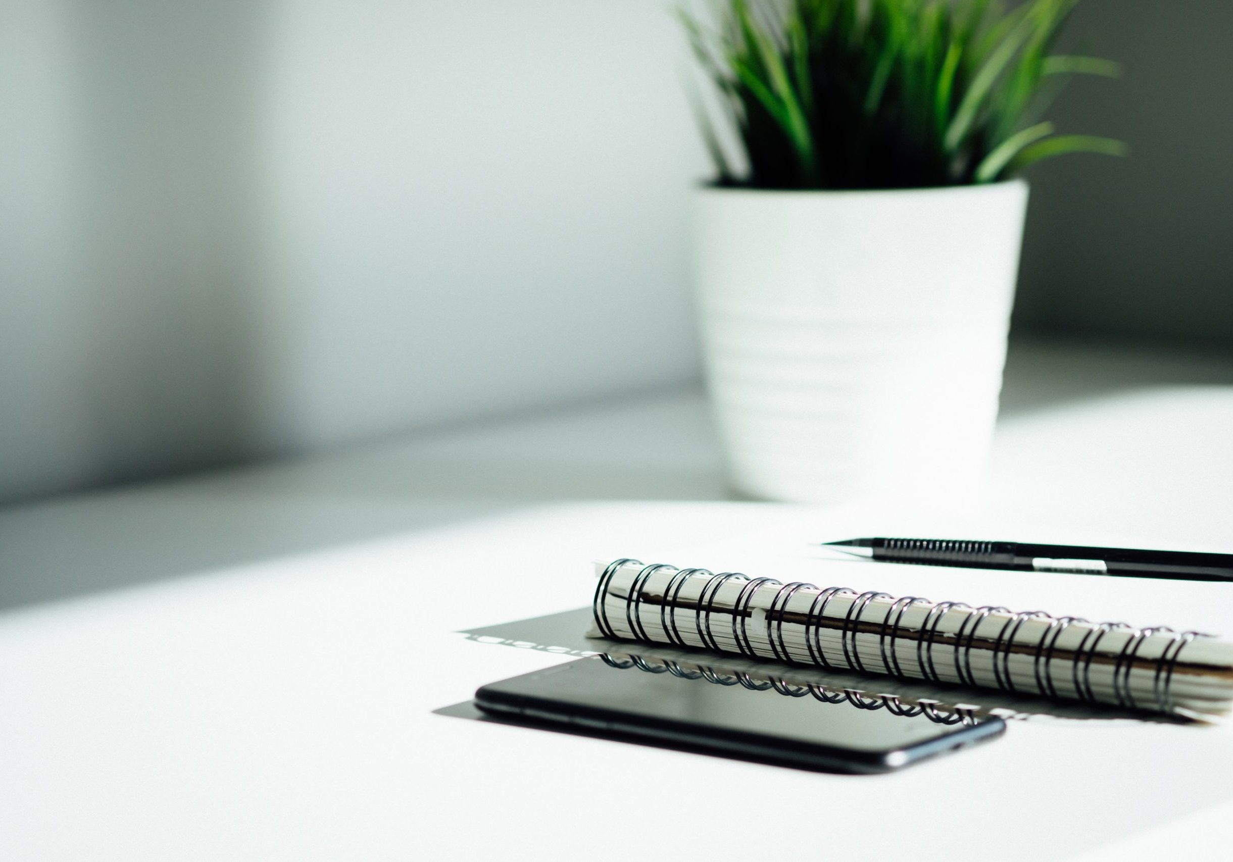 pen, notebook, and smartphone on table