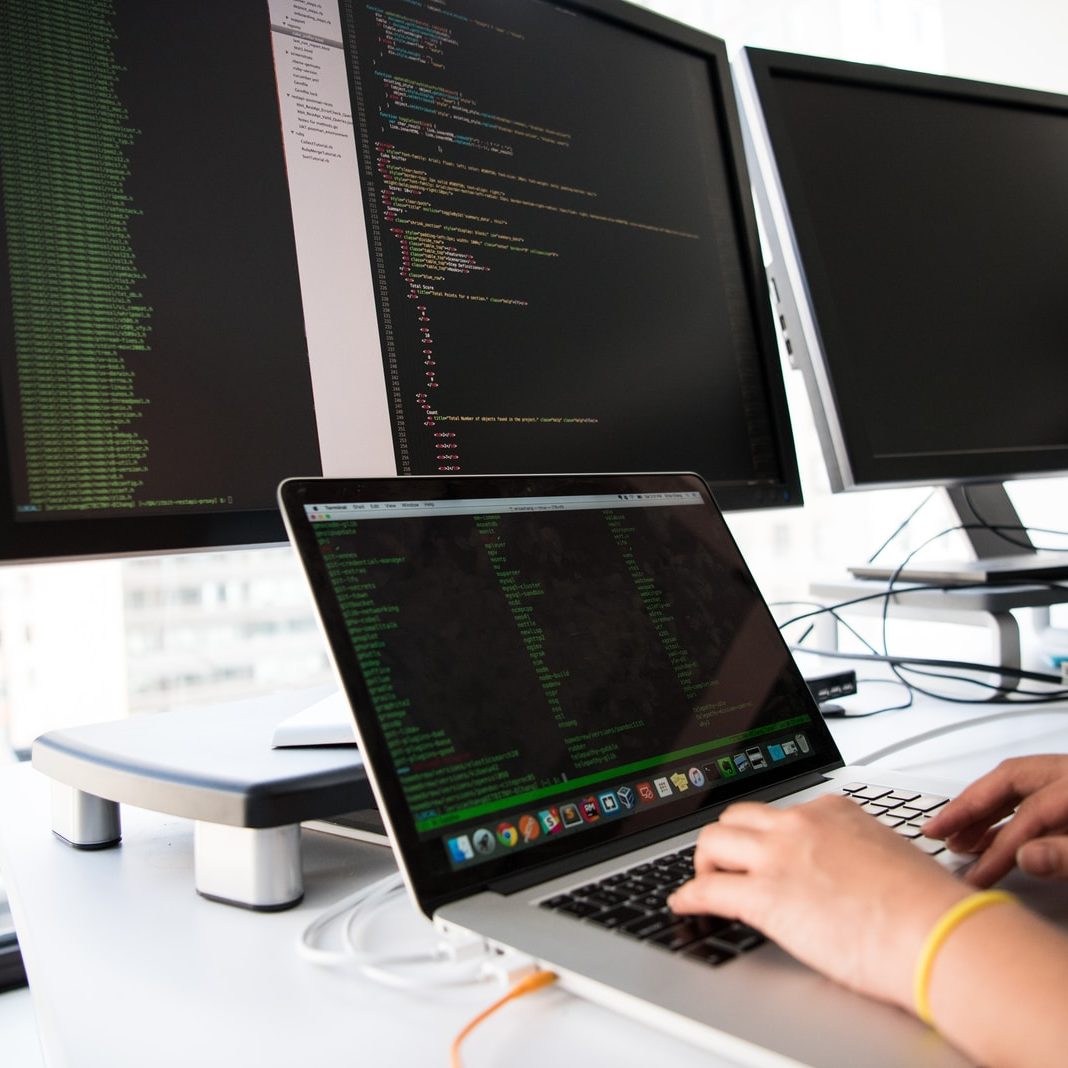 shallow focus photo of person using MacBook