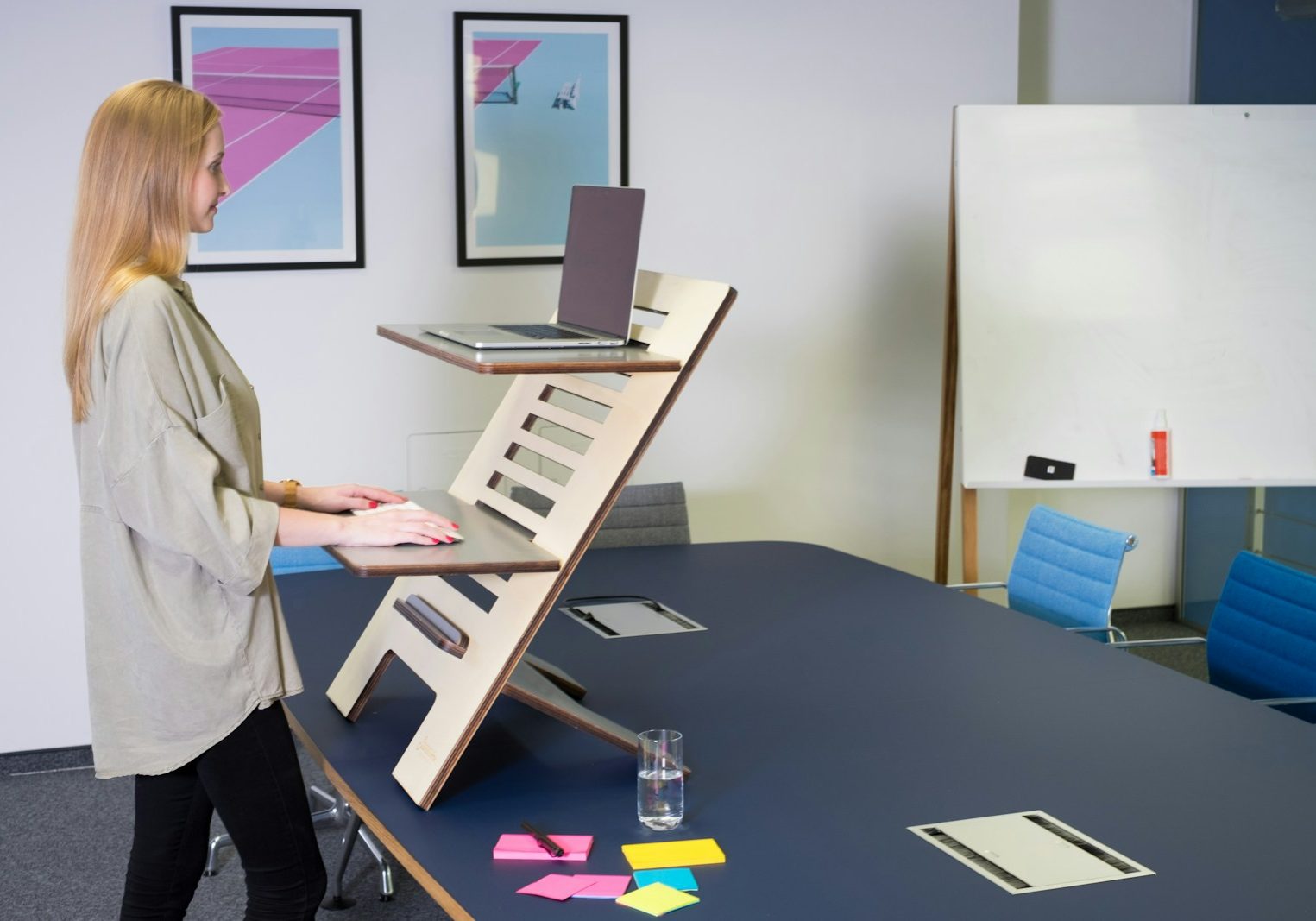 man in white dress shirt standing near black table