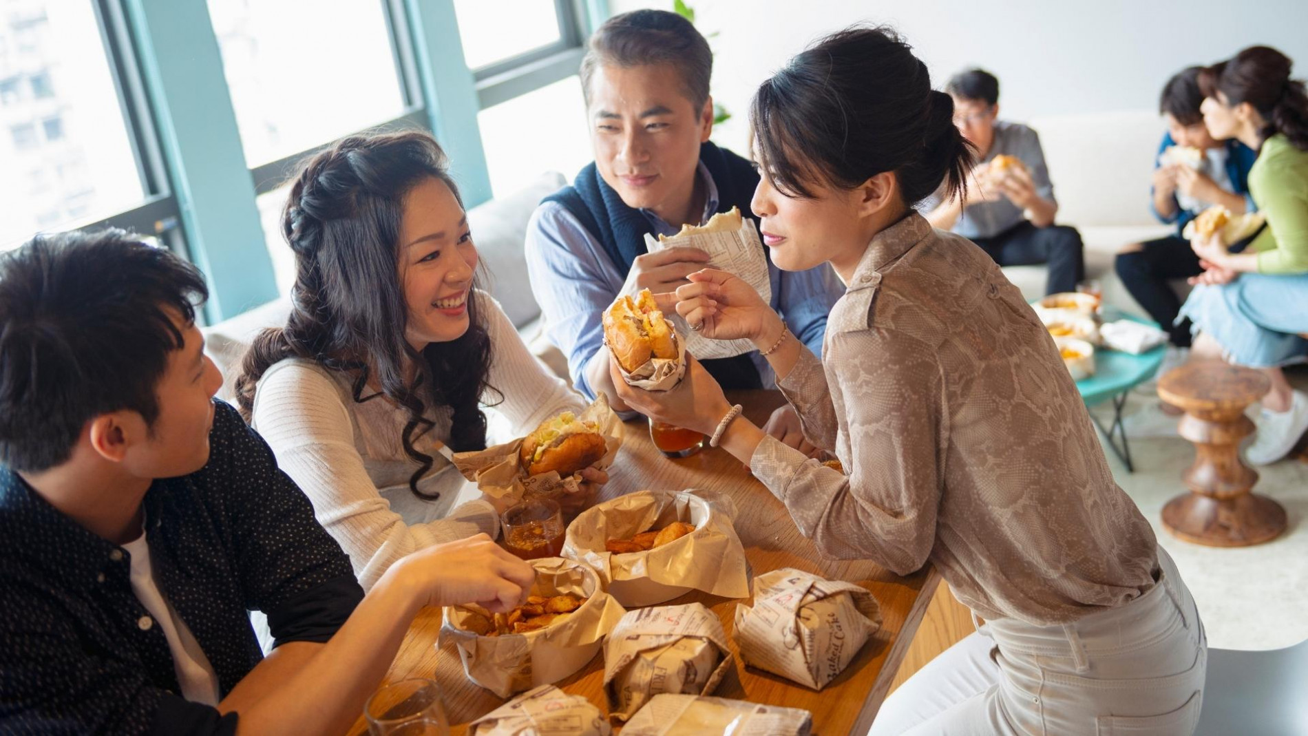 A group of 2 men and 2 women having tea time.