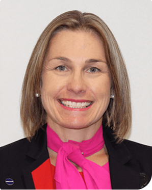 A headshot of a Qantas employee smiling at the camera