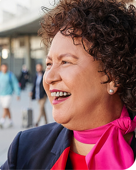 A headshot of a Qantas employee smiling at the camera