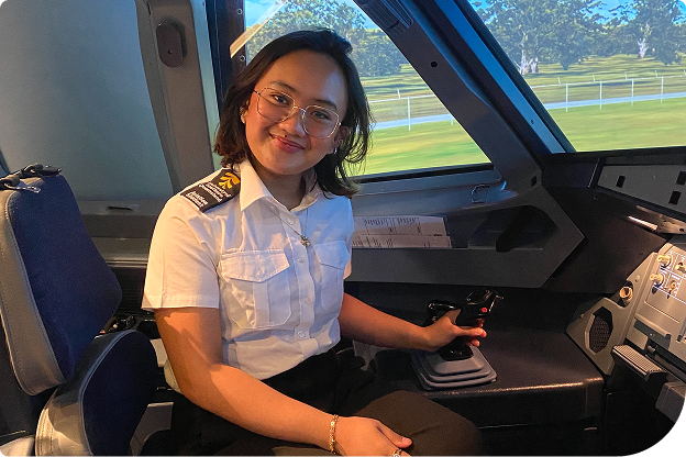 Female in the cock pit smiling at the camera