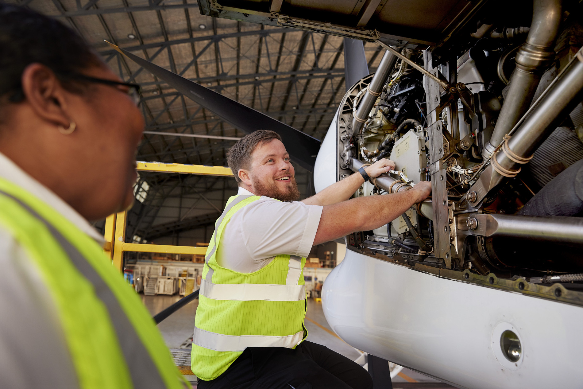 A Qantas engineering apprentice smiling at the camera