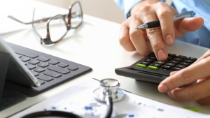 International medical graduate using a calculator to plan the costs of relocating a medical career to Australia