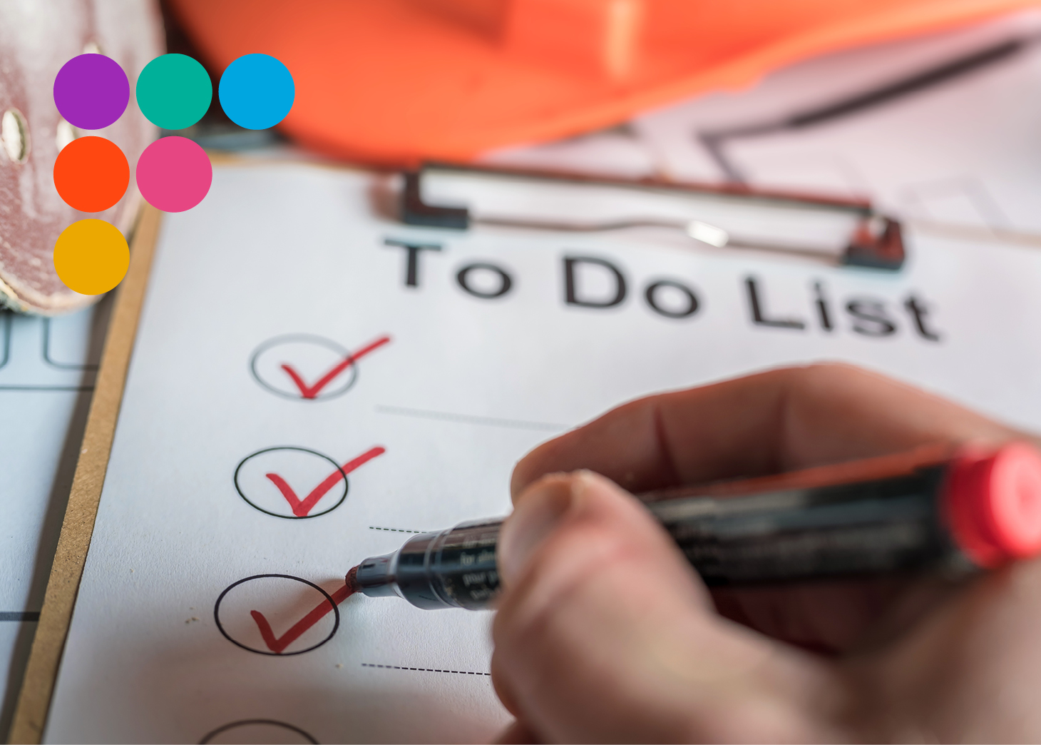 Person ticking a to-do list attached to clipboard