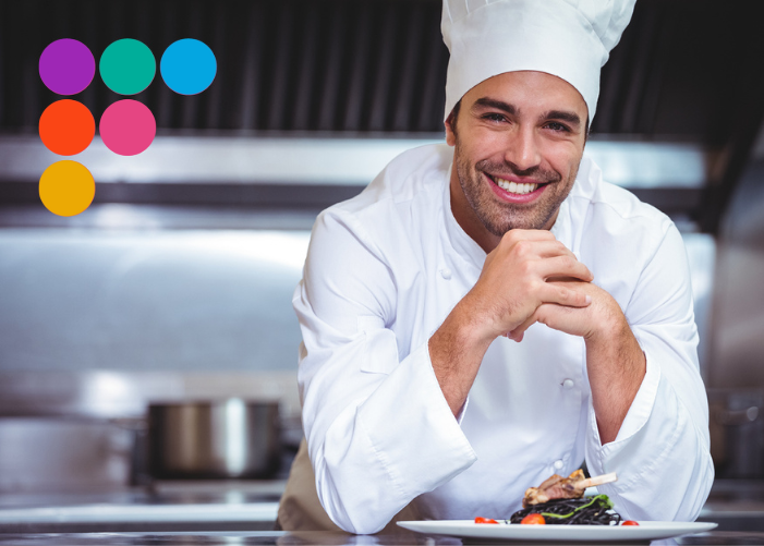 man in chef hat smiling at camera