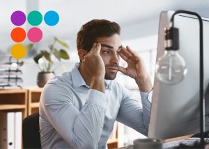 Man looking stressed at computer screen