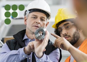 Two manufacturing men examining equipment