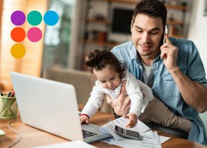 man holding a baby while working