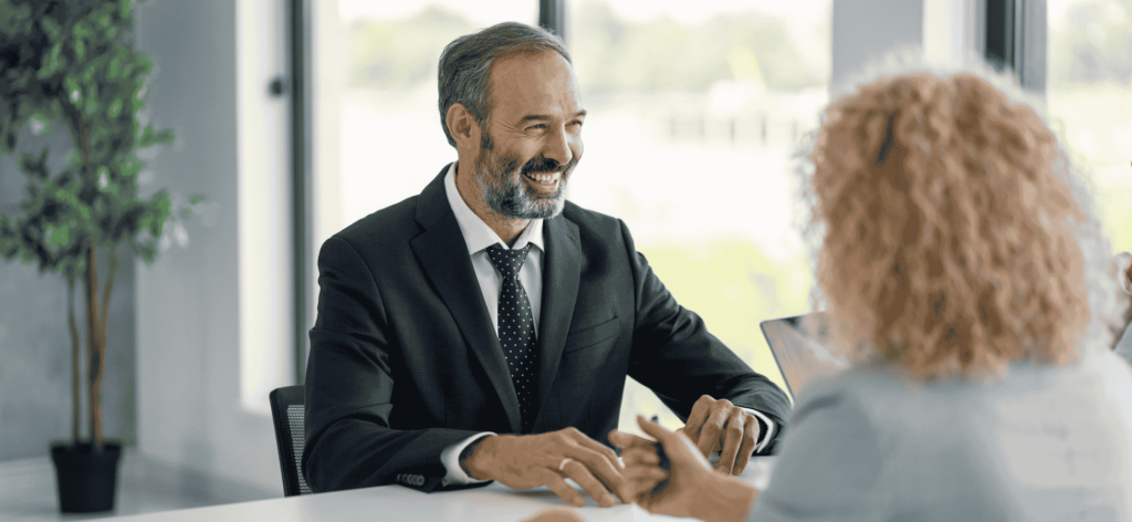 Claims Consultant meeting with a client to review insurance claims and provide support in an Australian office.