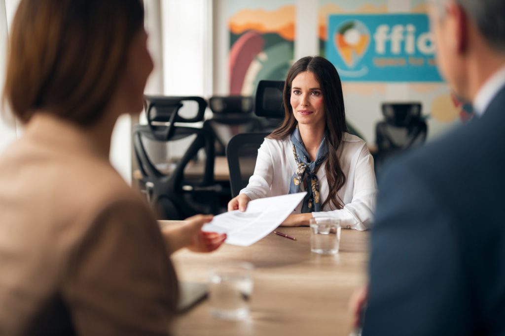 Client Services Officer supporting clients and managing documentation during a professional meeting in an Australian office.