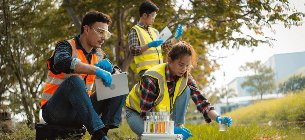 Environmental scientists performing fieldwork and analysing water quality at a research site in Australia.