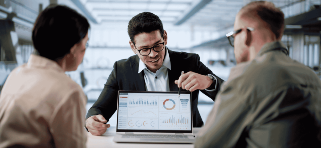 Financial Adviser reviewing investment performance data and providing strategic financial advice to clients in an Australian office.