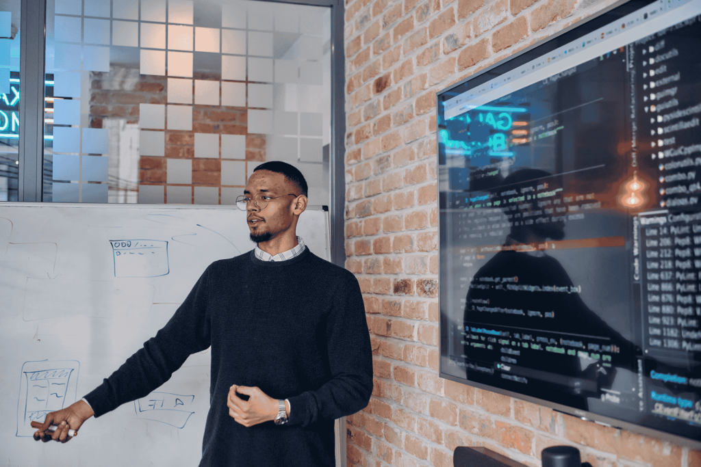 Recruiter presenting AI-driven hiring technology on screen during a Fuse Recruitment strategy session, showcasing data analytics and automation tools shaping the future of recruitment.