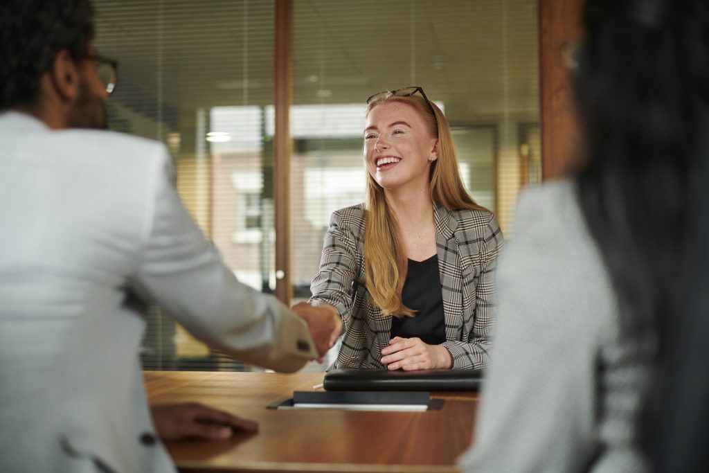 Woman shaking hands with a professional contact during a career development discussion