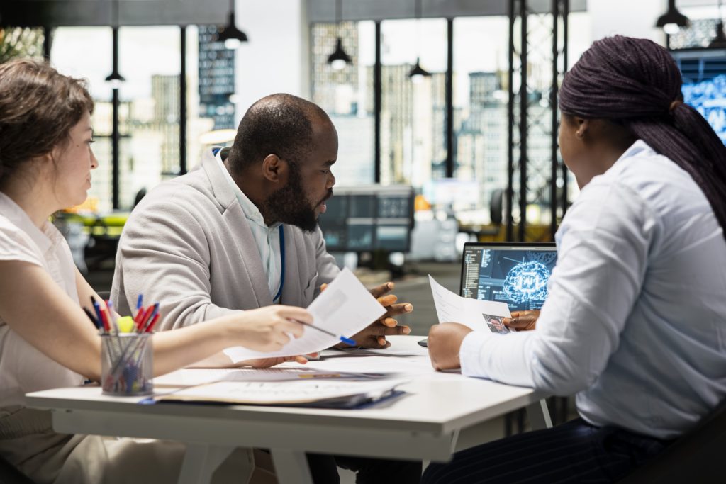 Professionals discussing AI literacy in an office.