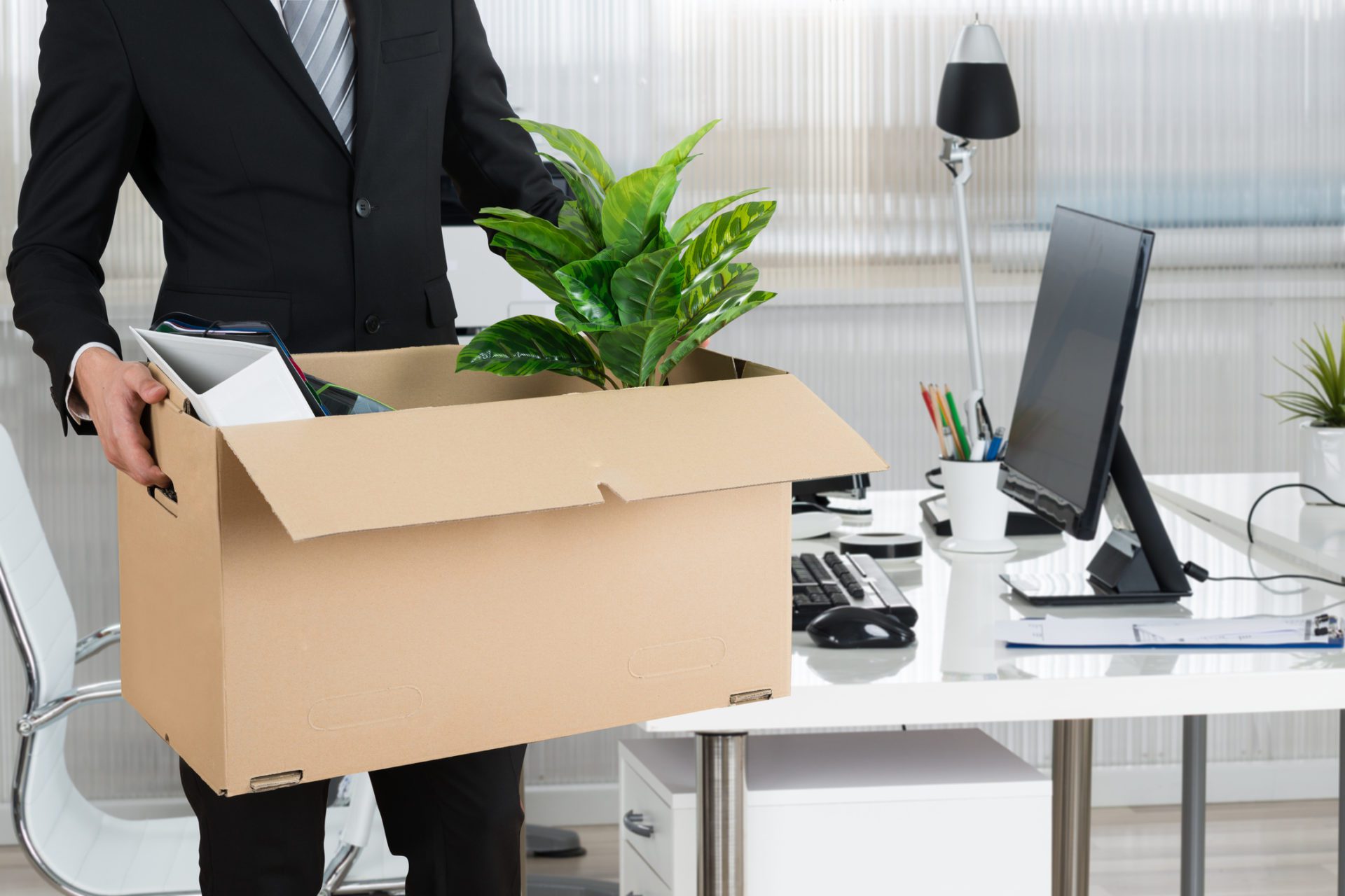 Midsection Of Businessman Carrying Cardboard Box