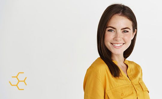 female smiling in yellow shirt with flexhive logo