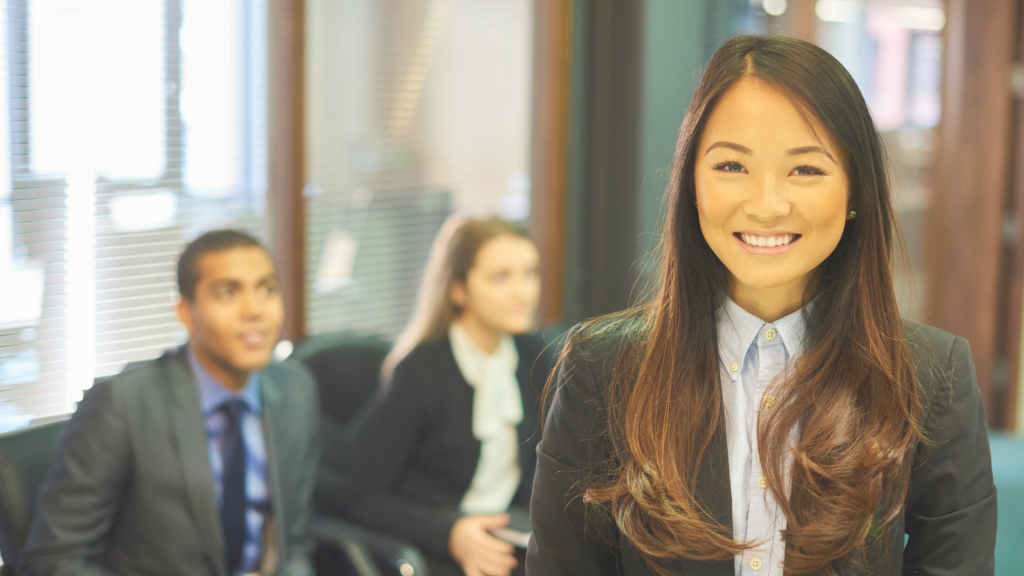 Women in office attire smiling