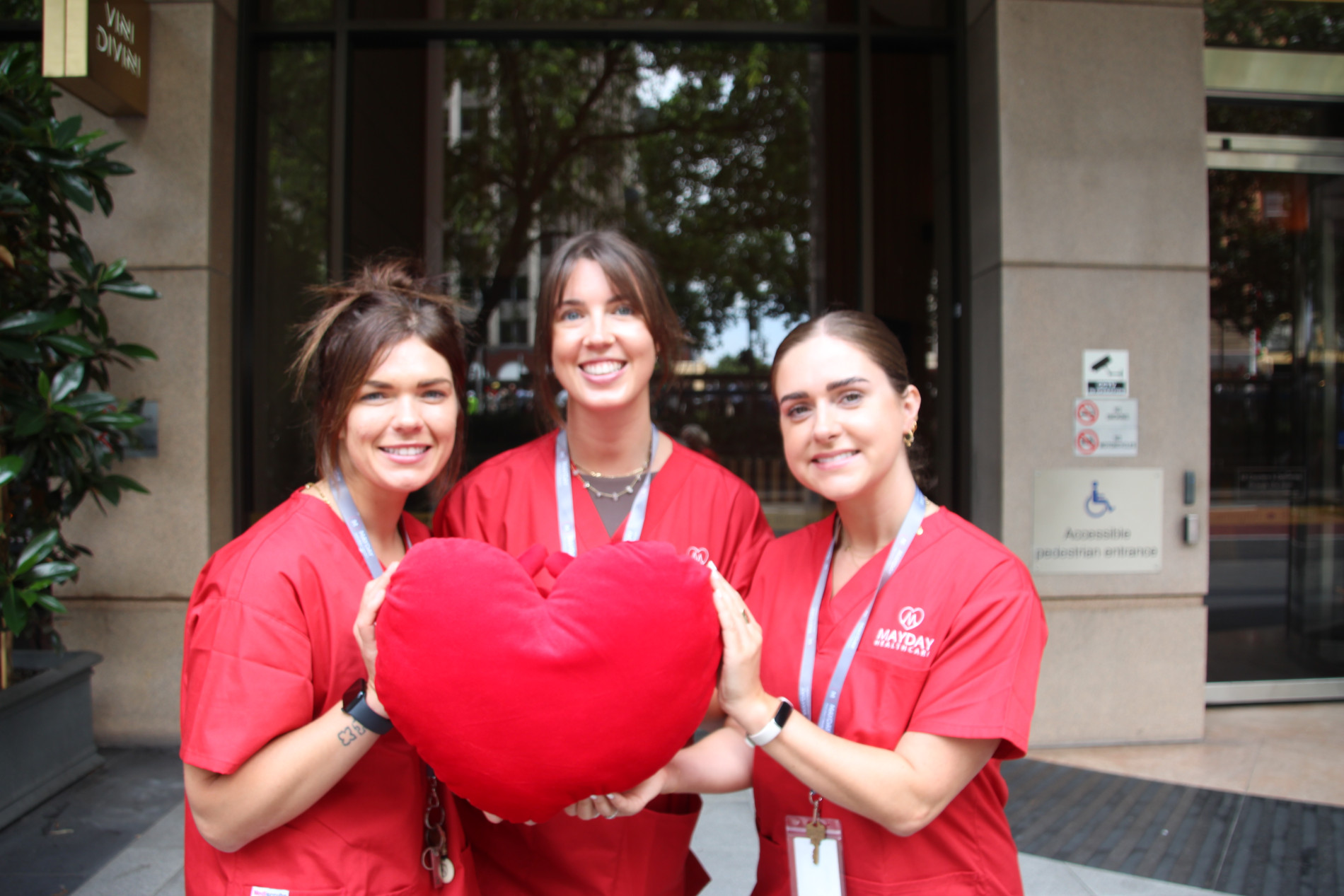 mayday healthcare nurses holding a cushion heart