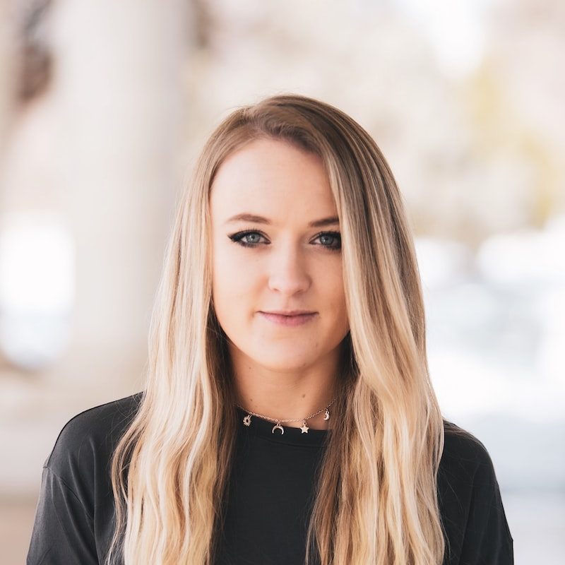 woman in black blazer with brown hair