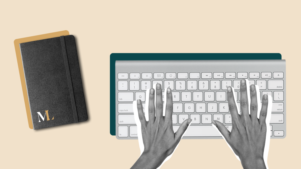 Hands typing on a keyboard with a notepad