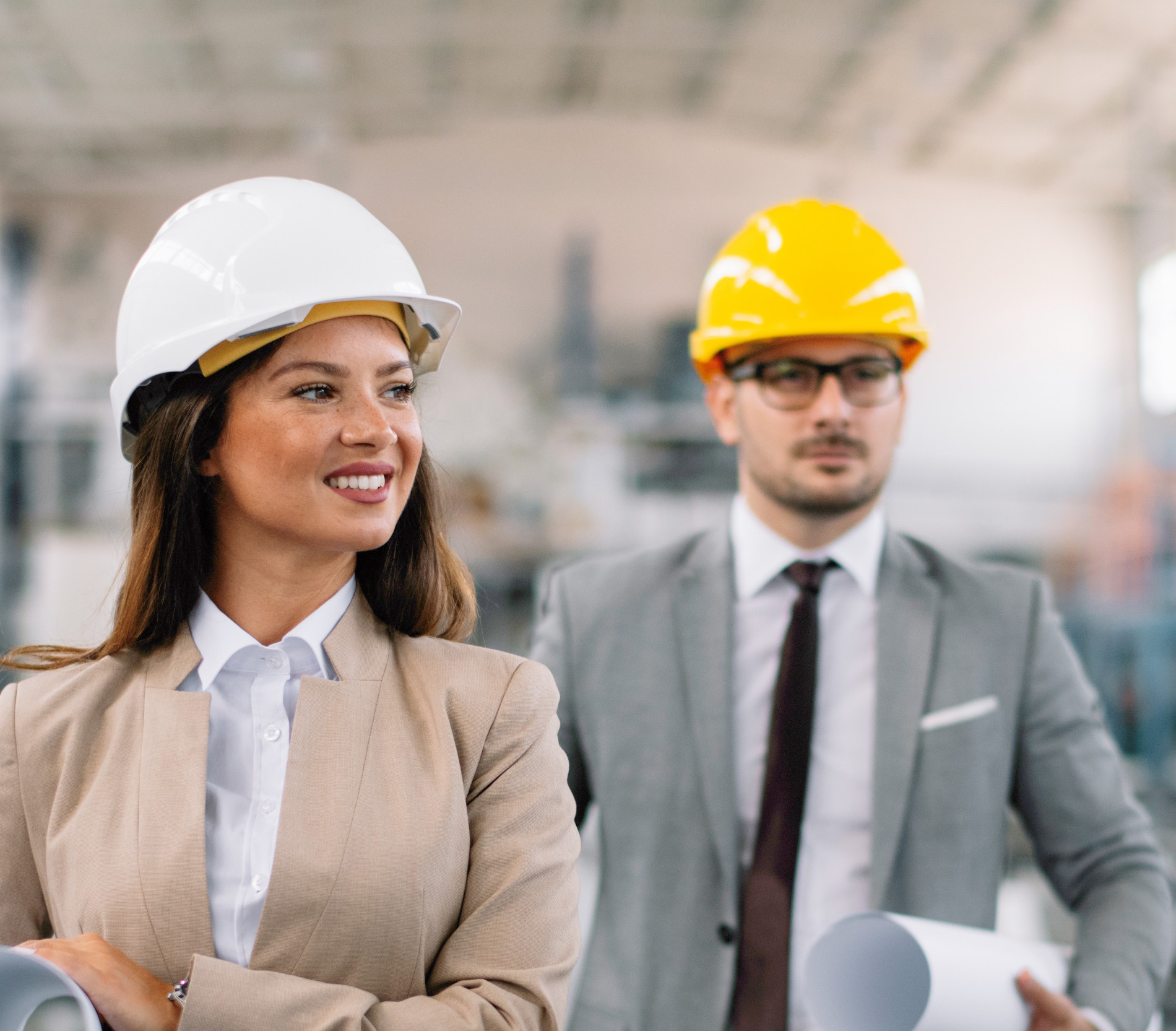 Engineering man and woman in hard hats and suits
