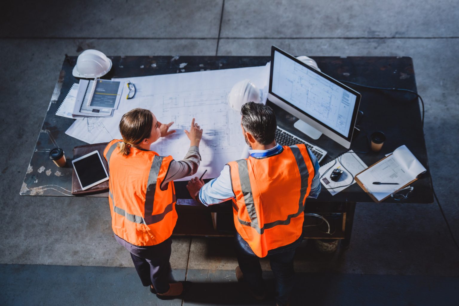 Engineer and trades supervisor reviewing project plans on-site Engineer and trades supervisor reviewing project plans on-site, symbolising the importance of hiring qualified trade professionals.